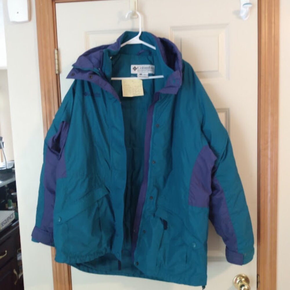 Columbia: Woman's green and purple winter coat with snap & zipper closure.